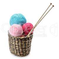 balls of wool and knitting needles isolated on a white backgroun