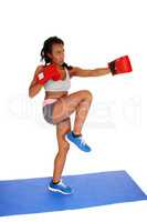 Boxing woman on blue mat.