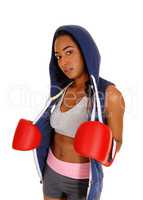 African woman in hoodie and red boxing cloves.