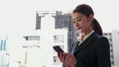 Happy Japanese Asian Businesswoman Talking On Phone Near Office Buildings