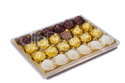 Chocolate sweets in the box on the white background.