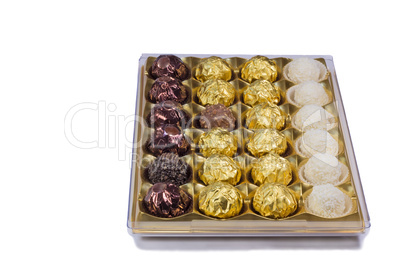 Chocolate sweets in the box on the white background.