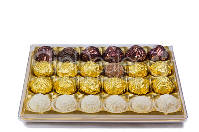 Chocolate sweets in the box on the white background.