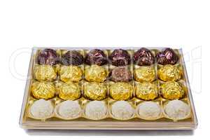 Chocolate sweets in the box on the white background.