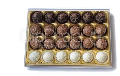 Chocolate sweets in the box on the white background.