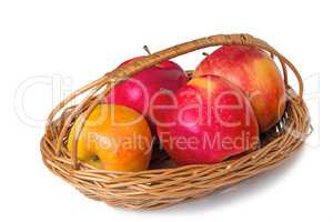 Big apples in wattled to a basket on a white background
