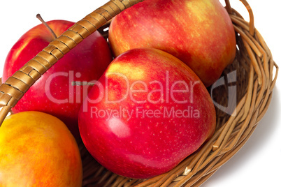Big apples in wattled to a basket on a white background