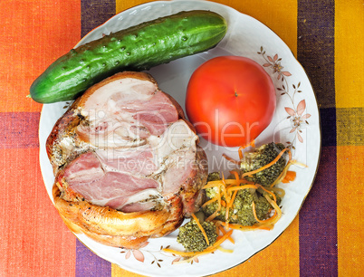 Smoked pork and vegetables on a white plate