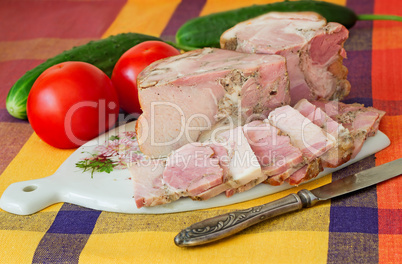 Smoked pork and vegetables on a white plate