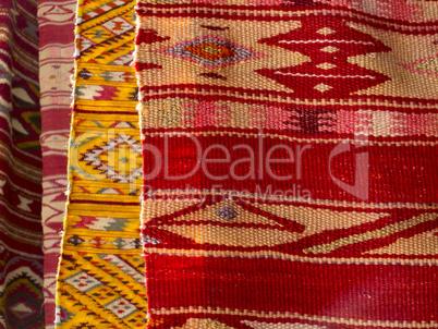 Close up of four hanged colourful handmade traditional wool rugs