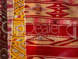 Close up of four hanged colourful handmade traditional wool rugs