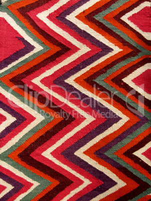 Close up of a hanged colourful handmade traditional wool rug