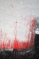 Brushstroke with white,black and red paint  on dusty metal