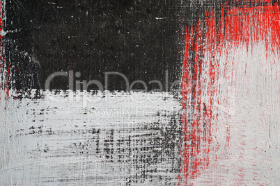 Brushstroke with white,black and red paint  on dusty metal