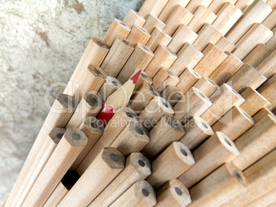 Close up of identical graphite pencils and one different red  cr