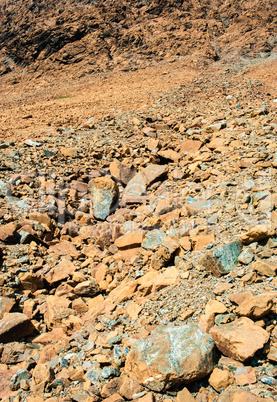 Dry yellow broken rocks on mountain slope