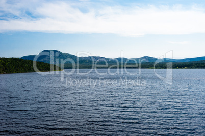 Lake among forested hills and mountain