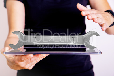 Hand with Tablet PC and wrench