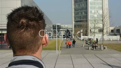 A man stands and looks on the street