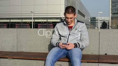 man works on the phone on the street