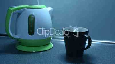 Boil water in a kettle and pouring tea on the kitchen counter