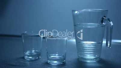 Two glasses and jug filled with water on the kitchen counter