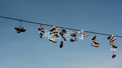 Shoes hang on a rope