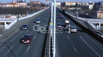 Cars drive on the Nusle Bridge in the city
