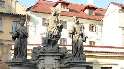 Religious statues on the Charles Bridge, in the background building