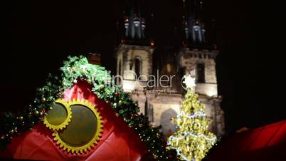 Christmas shop with branch and shining christmas tree - Old Town Square. In background historical building - in night