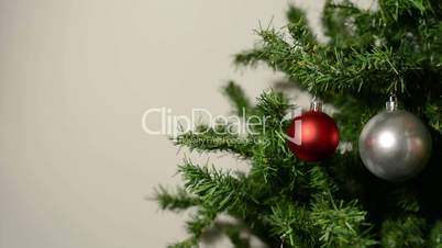 Decorating the Christmas tree with decorative balls - white background