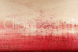 Brushstroke with red paint  on dusty metal fence