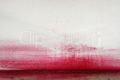 Brushstroke with red paint  on dusty metal fence