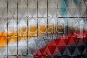 Facade with painted  ceramic triangular tiles