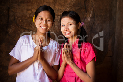 Two young Myanmar girls in welcoming posture