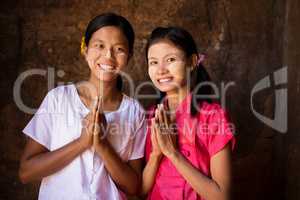 Two young Myanmar girls in welcoming posture
