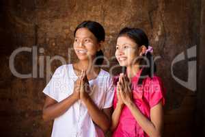 Two young Myanmar girls praying