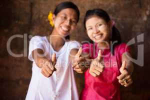 Two young Myanmar girls giving thumb up