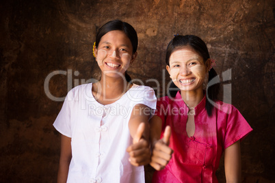 Two young Myanmar girls thumb up