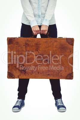 Mid section of a smiling hipster woman holding suitcase