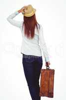 Rear view of hipster woman holding suitcase