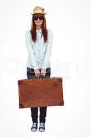 Portrait of a hipster woman holding suitcase