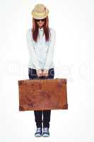 Portrait of a hipster woman holding suitcase