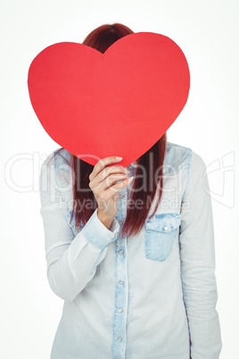 Attractive hipster woman behind a red heart