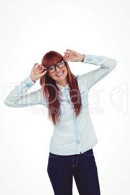 Smiling hipster woman holding her glasses