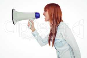 Side view of a hipster woman shooting through megaphone