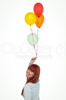 Smiling hipster woman holding balloons