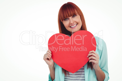 Smiling hipster woman behind a big red heart