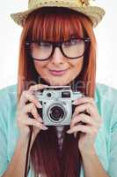 Portrait of a smiling hipster woman holding retro camera