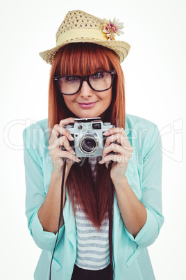 Portrait of a smiling hipster woman holding retro camera